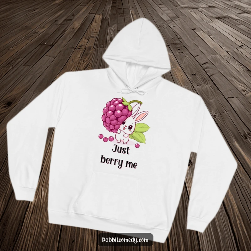 Funny hoodie depicting a surprised cartoon rabbit peeking with huge eyes from behind a comically large, wobbling berry, offering warmth and humor.